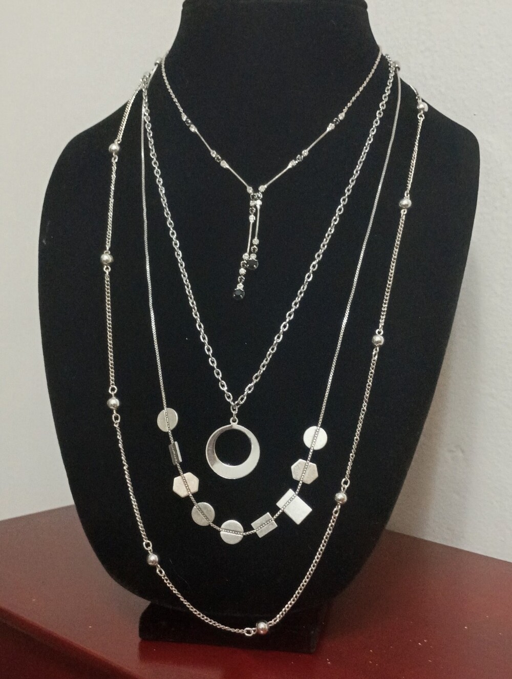 Four Silver Toned Necklaces in a variety of lengths and styles #geometric #layer